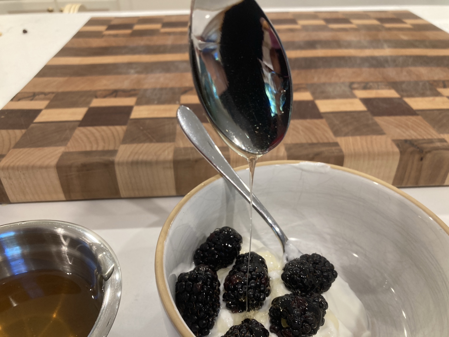 Compass and Comb wildflower honey drizzled over blackberries and yogurt