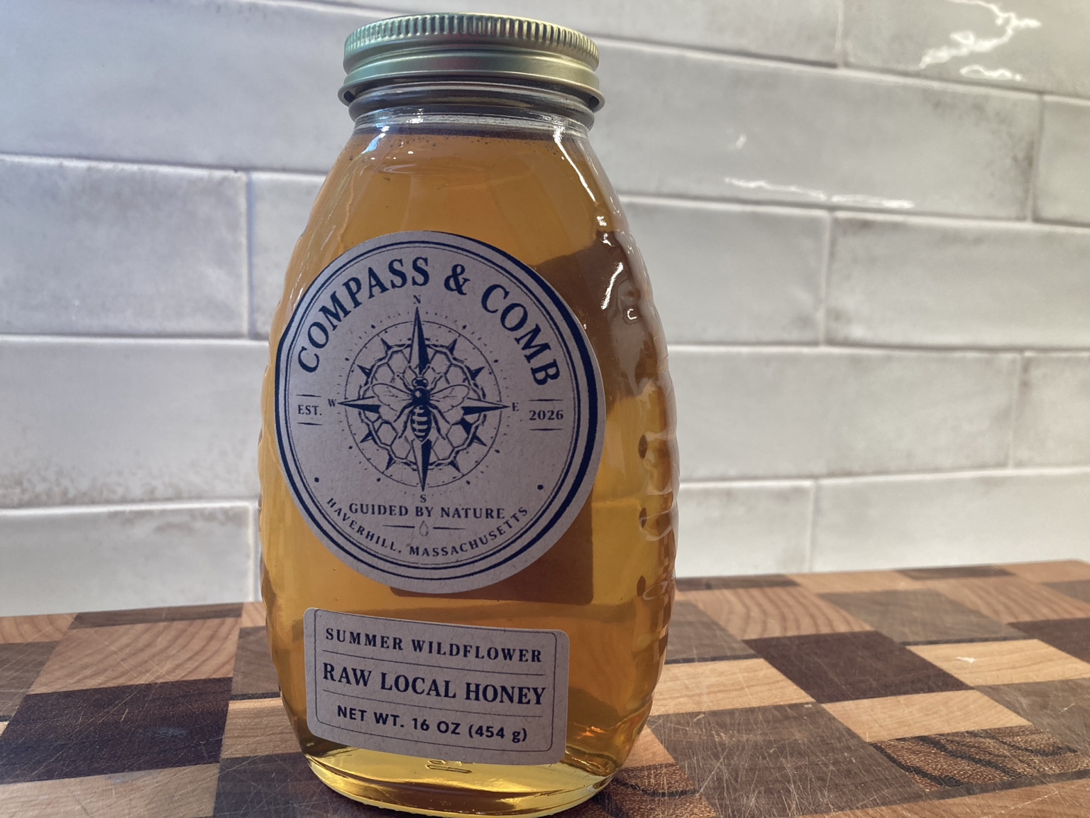 One-pound bottle of Compass and Comb Summer Wildflower raw local honey